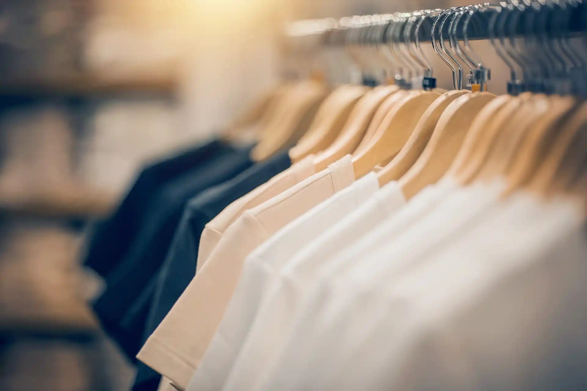 Row of clothes on hangers in a store setting