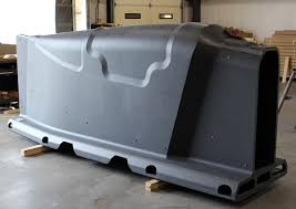 Large 3D printed part in warehouse setting.