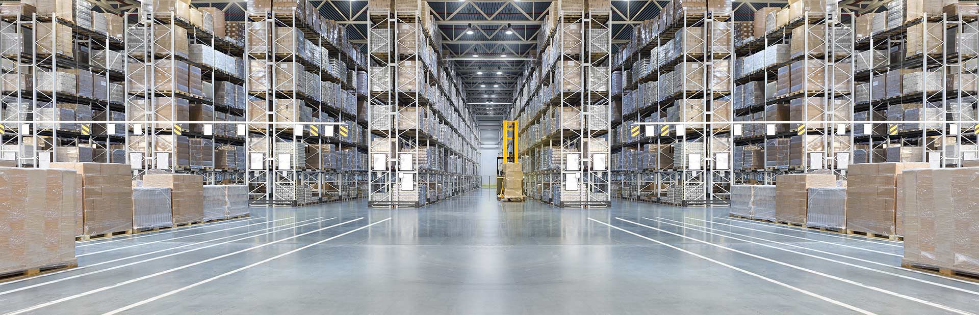 Large warehouse with high shelves and pallets