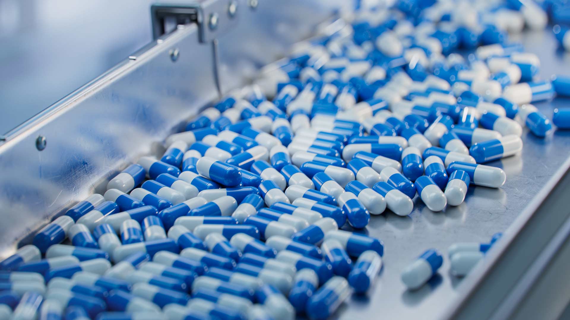 Blue and white capsules on a production line