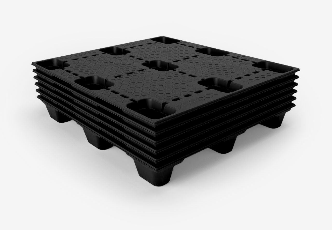 Stack of black plastic pallets on a white background