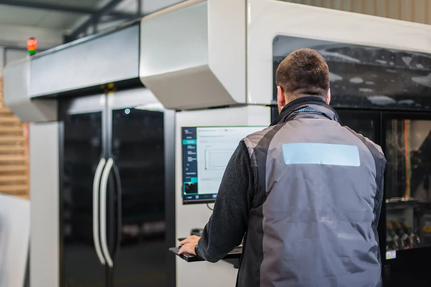 Person operating a machine with a control panel in an industrial setting