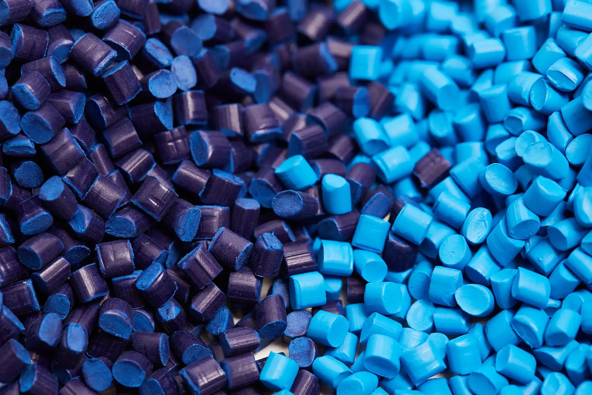 Close-up of blue and purple plastic pellets.