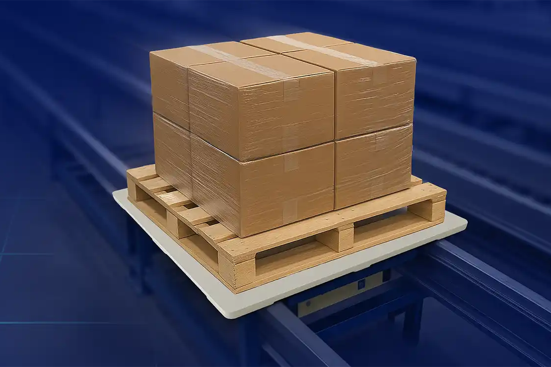 Stack of cardboard boxes on a wooden stringer pallet on a transfer board in an automated warehouse.